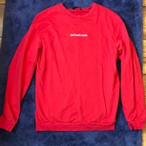 Crew neck light sweater. Red says “ Don’t Need Reason “